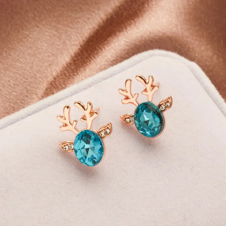 Boucles d'oreilles en métal avec un renne de Noël en cristal