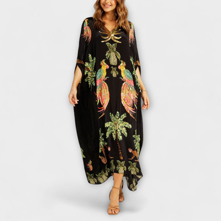 Linda - Robe impressionnante avec des bretelles asymétriques et un imprimé de palmiers
