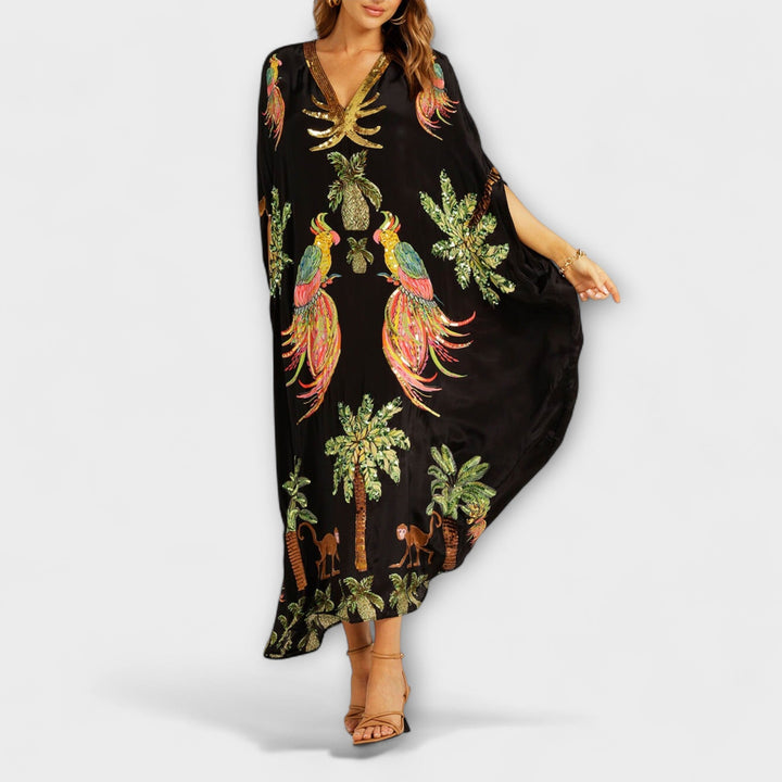 Linda - Robe impressionnante avec des bretelles asymétriques et un imprimé de palmiers